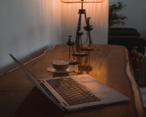 minimalist desk setup with natural light and wood textures for visual comfort